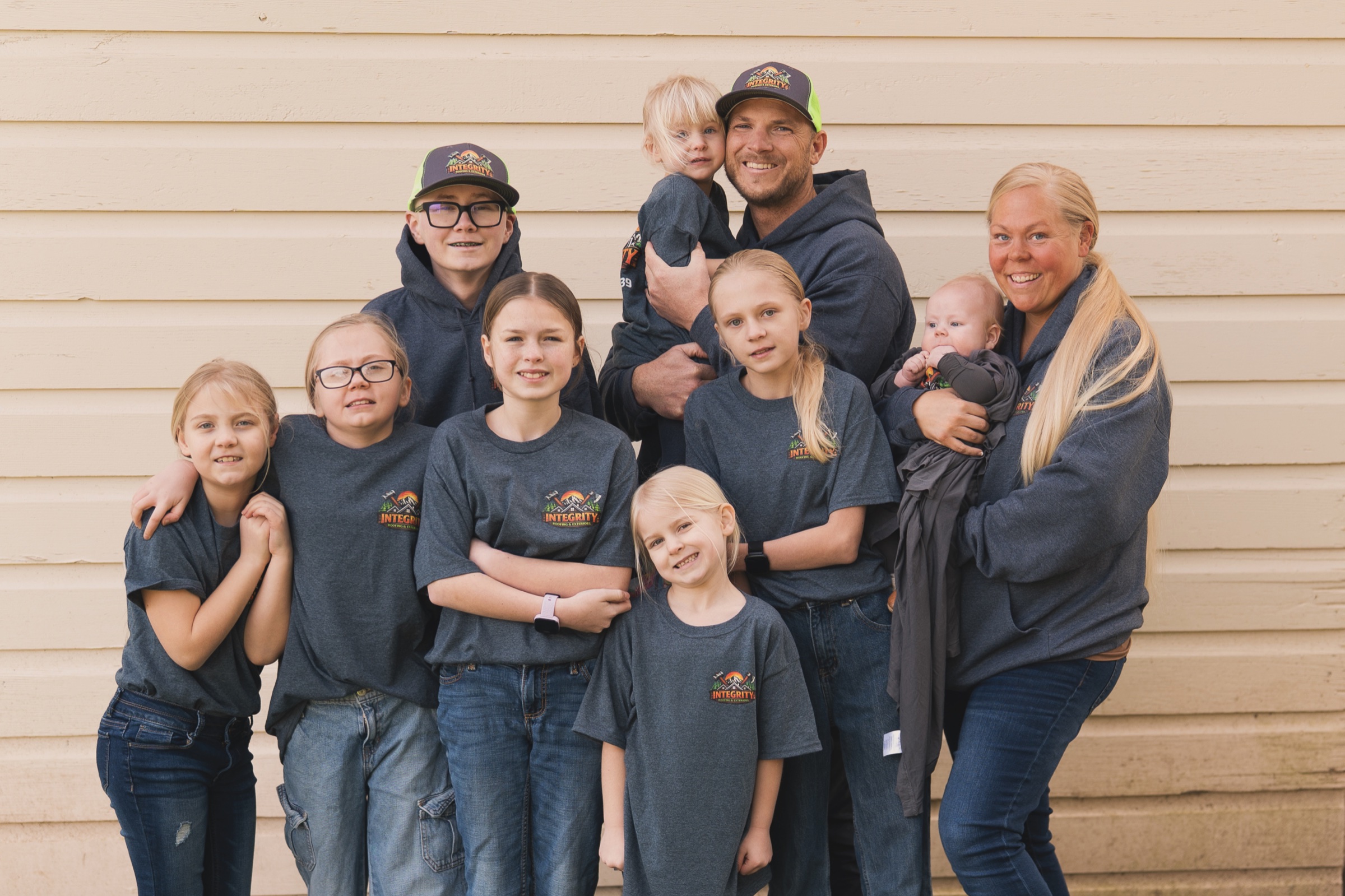 The Integrity Roofing & Exteriors family in matching company apparel